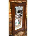 A walnut and parcel gilt wall mirror, with bevelled plate