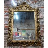 An 18th century carved gilt-wood framed mirror in the rococo style, 140 cm w x 98 cm