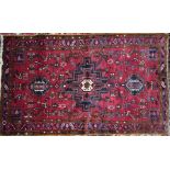 A Persian Heriz rug, 238 cm x 145 cm