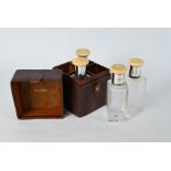 Leather-cased set of four glass spirit flasks