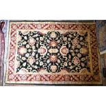 An Agra palmette design dark ground rug, 210 cm x 148 cm