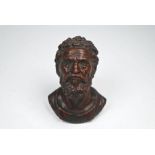 A small carved walnut bust of a bearded man