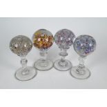 Four floral glass pedestal paperweights