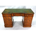 A Victorian walnut inverted breakfront pedestal desk