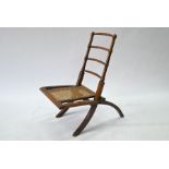 An antique walnut framed cane seat folding campaign chair