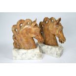 A pair of large carved onyx horse head bookends on marble bases (2)