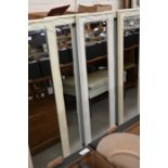 A pair of cream painted moulded framed mirrors