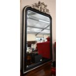 A large Empire style ebonised and silvered overmantel mirror