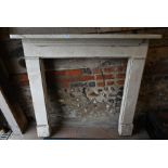 A white painted wooden fire surround