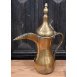 An antique brass Turkish coffee pot