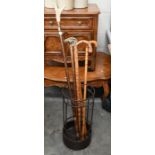 A metal stick stand to/w five assorted walking sticks