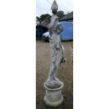 A classical garden sculpture of a semi-clad female wine carrier
