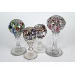 Four floral glass pedestal paperweights