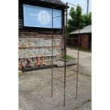 A pair of weathered steel garden screens