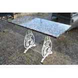 A marble top garden table on wrought iron base