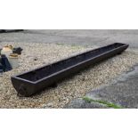 A large antique cast iron feeder / water trough