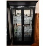 A large ebonised glazed display cabinet