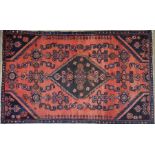 A Persian Hamedan runner, the dark diamond medallion on red ground with navy spandrels and border,