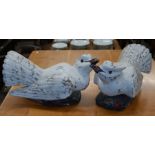 A large pair of carved wooden birds