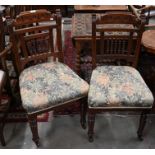 A set of six Edwardian carved and moulded oak framed side chairs