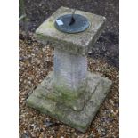A cast stone two-piece garden sundial