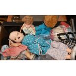 Four plastic dolls with clothes