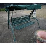 A green garden swing bench seat