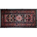 An old Persian Heriz rug, 205 cm x 105 cm