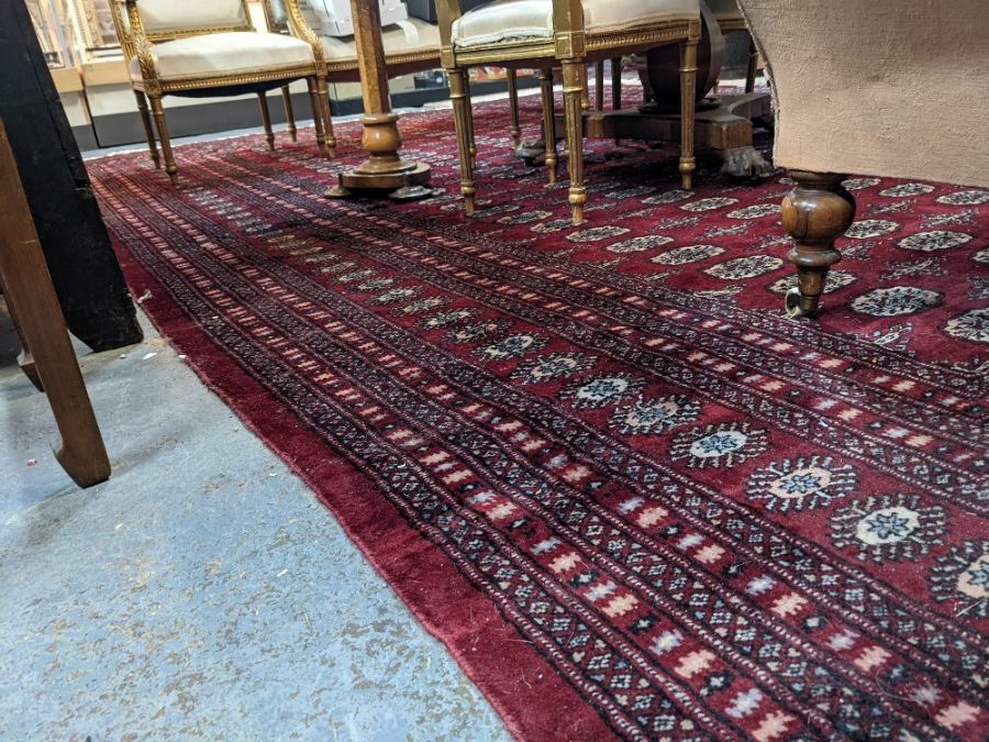 A large Persian Turkoman design red ground carpet, 410 cm x 310 cm - Image 3 of 3