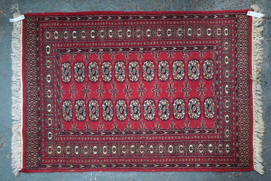 A red ground Persian Turkoman design rug, 137 cm x 94 cm