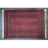 A red ground Persian Turkoman design rug, 137 cm x 94 cm