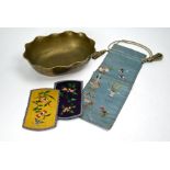 A Chinese brass dragon bowl, silk embroidered pouch and two badges