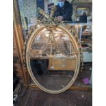 A Sheraton design giltwood and cream finished oval mirror