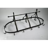 An antique style blackened wrought steel hanging meat rack / kitchen utensil holder