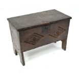 A small 17th century carved oak six plank coffer with staple hinged top
