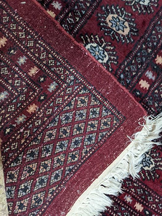 A large Persian Turkoman design red ground carpet, 410 cm x 310 cm - Image 2 of 3