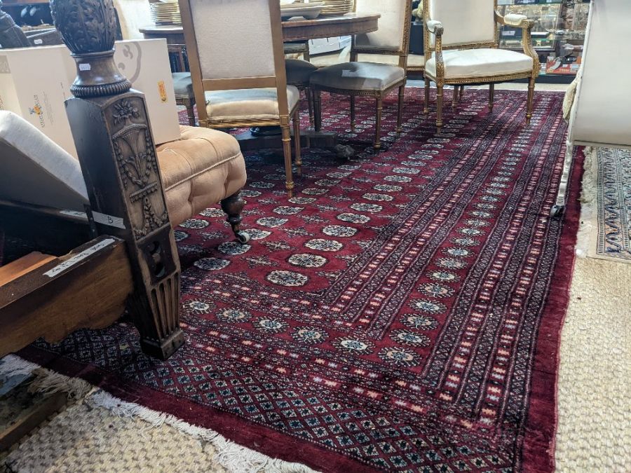 A large Persian Turkoman design red ground carpet, 410 cm x 310 cm