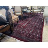 A large Persian Turkoman design red ground carpet, 410 cm x 310 cm