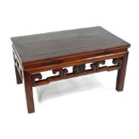 A 20th century Chinese hardwood low table with pierced moulded frieze