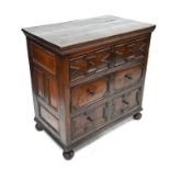 An antique oak chest of three long graduated drawers
