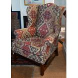 A traditional Kelim upholstered wing armchair by Newlook, Hampshire