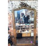 A large 19th century giltwood and composite arched top mirror