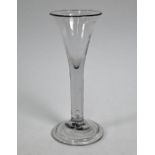 An antique cordial glass with flared conical bowl