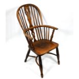 An antique oak/elm hoop back Windsor armchair with crinoline stretcher