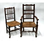 A set of six Georgian oak spindle back rope seat country chairs to/w a similar carver
