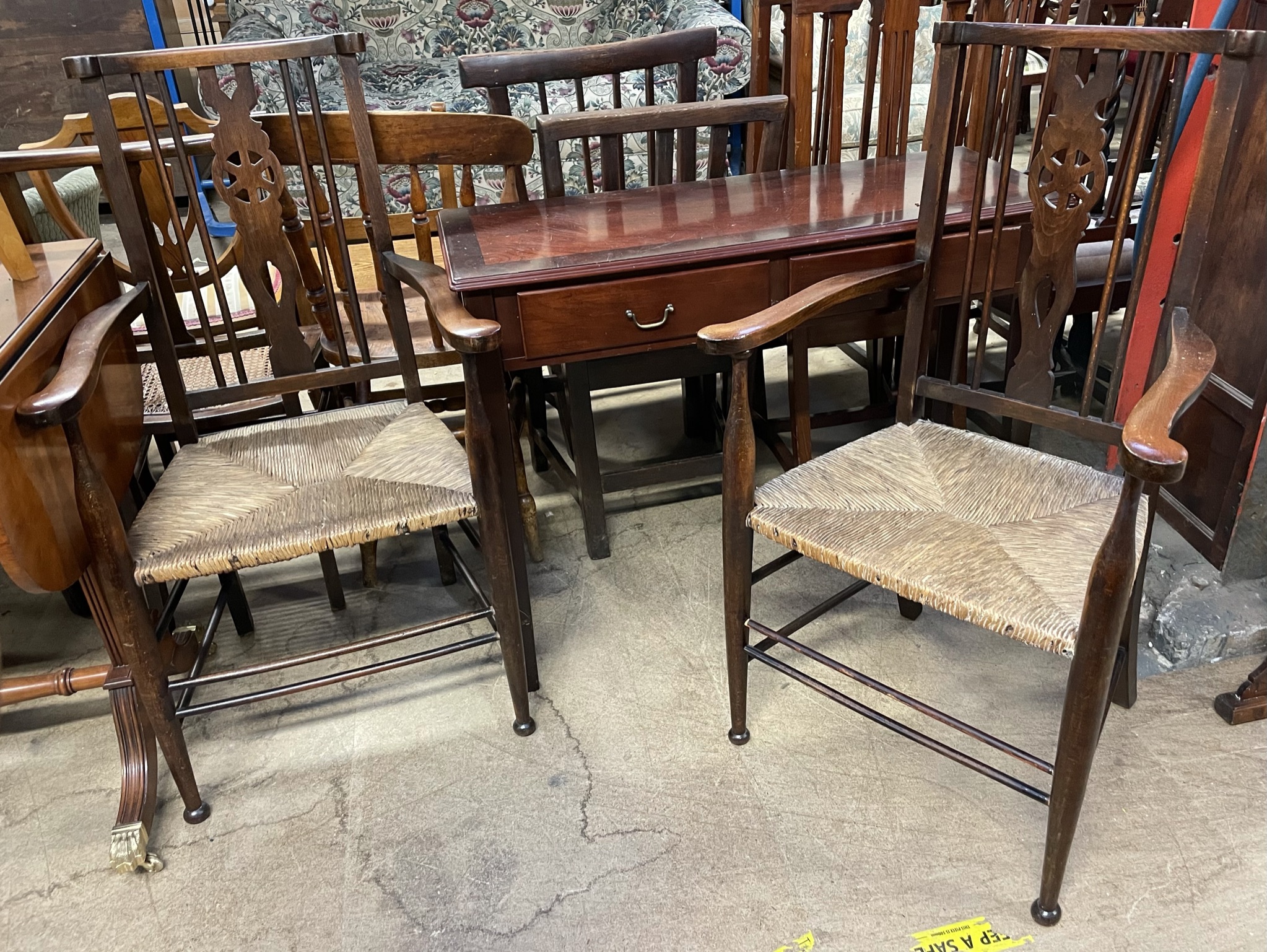 A pair of Arts and Crafts style elbow chairs together with a reproduction mahogany side table