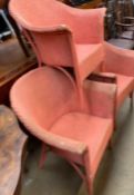 A set of three red painted Lloyd Loom elbow chairs