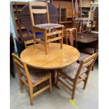 A 20th century ash dining table of circular form on a pedestal together with four chairs