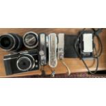 An Olympus Pen E-PL1, digital camera together with a fish eye lens, and two other lenses,