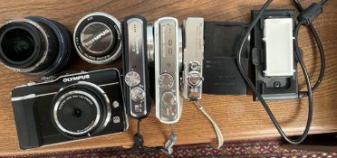 An Olympus Pen E-PL1, digital camera together with a fish eye lens, and two other lenses,